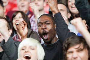 Cheering man at football match